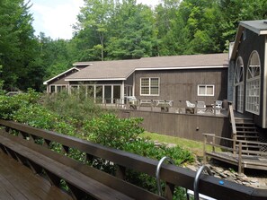 Looking across stream from pool deck to main dining area deck