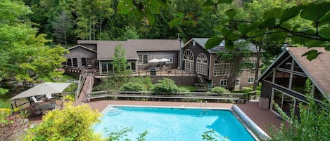 Overview of house from hill behind pool. 