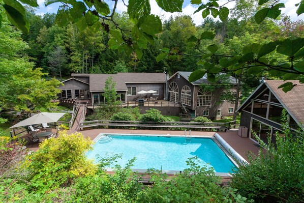 Overview of house from hill behind pool. 