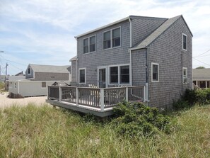 The ocean facing deck with dining table and Weber Grill
