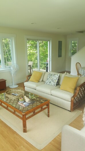 Sunny living/dining room looking out to the lake. Porch/patio out the sliders.