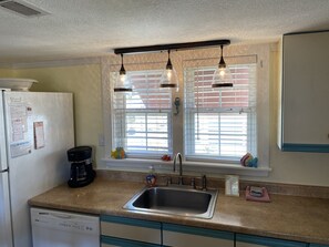 Retro lighting over sink area w/ dimmer switch .coffee maker .filters provided 
