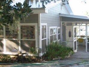 This is the porch entrance.  L-shaped porch is comfortable,dining table & glider