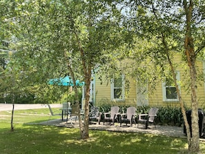 Side yard, shaded by birch trees