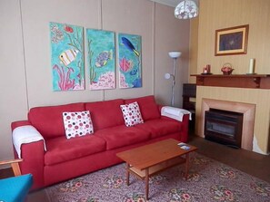 Comfy family sofa and chairs in with TV, DVD, video. Gas Heater.