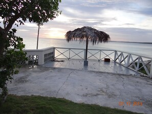 Patio just off of the driveway, overlooking the water, ground level