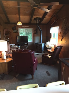 Looking into the Living room from dining room. Nice ceiling fan cools the area.