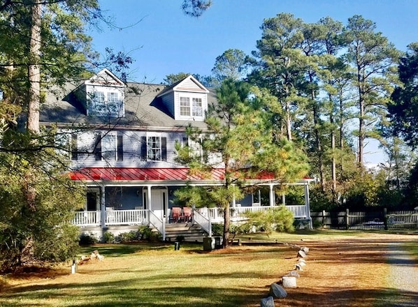 Our home blends into towering pines, lawns & hundreds of feet of waterfront