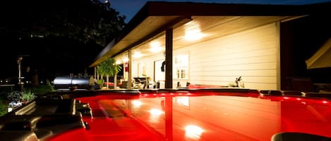 Night time Hot tub facing back porch 