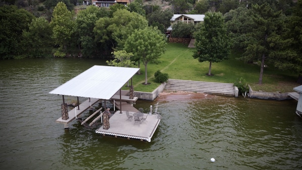 Aerial view of the boat dock, steps leading into the lake and swimming area.