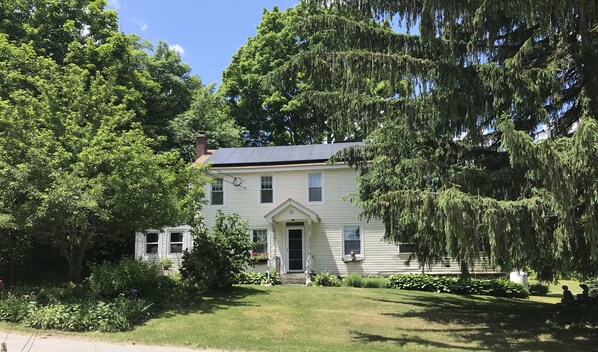 Front of house, driveway on left.