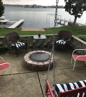 stone fire pit on the lower deck overlooking the lake