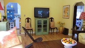 Large Flat Screen TV with Game Cabinet and Entry to  Dining Room,  and Kitchen 
