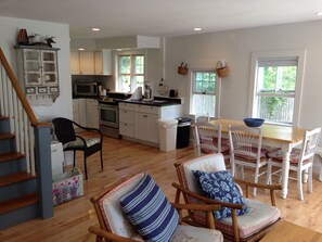 View of dining table (four chairs and a bench on the other side for up to four)