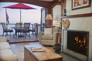 Living room with cozy fireplace and pull out sofa bed.