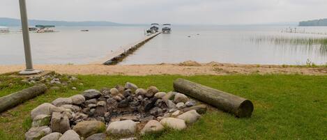 Lake side fire pit and shared dock. 