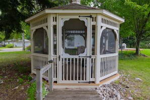 Charming, screened gazebo with plenty of seating. 