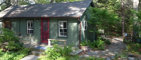 Dappled shade and flower gardens add to the relaxed comfort of this cabin.