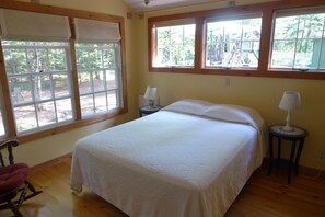 A comfy queen size bed in a marvelous space.