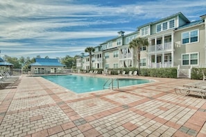 Over-sized community pool steps from house.