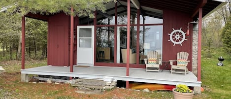 Living/dining rooms & porch overlook the sandy beach & Lake Michigan.