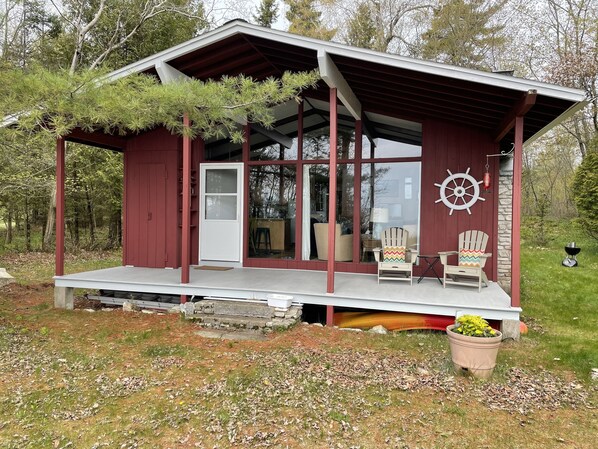 Living/dining rooms & porch overlook the sandy beach & Lake Michigan.