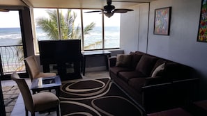 Living room area with large TV and work desk area