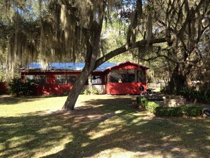 Lakeside View of Cottage with Screened Porch, Outdoor Terrace, and Fire Pit