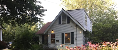 Front of house with flowers in the garden.