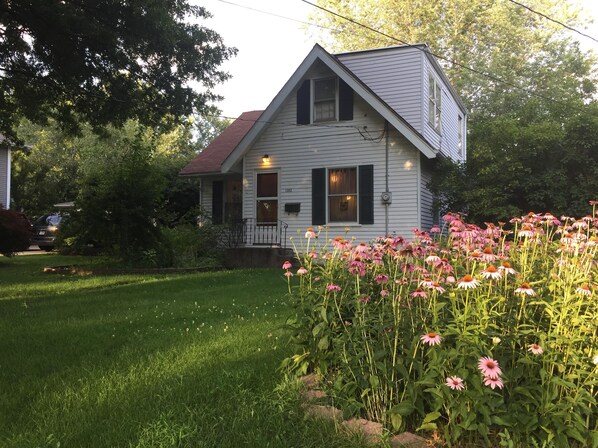 Front of house with flowers in the garden.