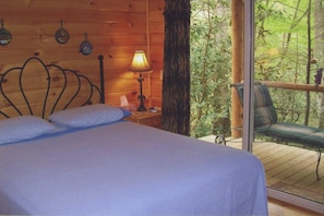 Bed Room/ sliding glass doors open to back pourch overlooking creek