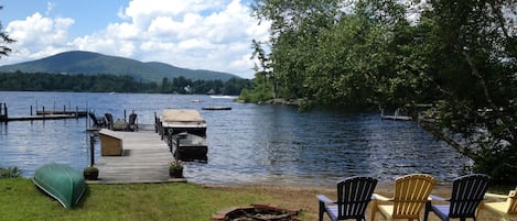 Lake front with dock, private sandy beach, fire pit, canoe and row boat