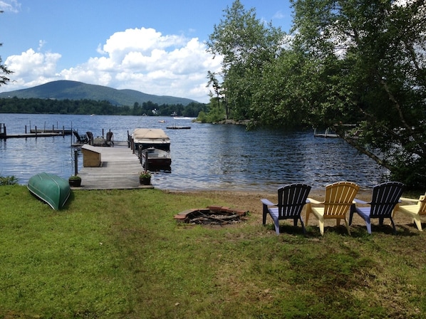 Lake front with dock, private sandy beach, fire pit, canoe and row boat