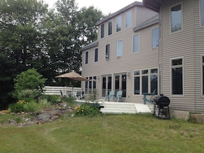Deck has bench seats, umbrella table, picnic table, dual charcoal/gas grill.