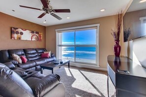 Living room with a view, comfy sofas, 55 inch LED flat screen TV and ceiling fan