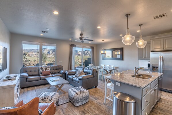 Living Room View - The living room is designed as an open floor plan and is a great gathering place for meals, games, or watching TV during your stay.