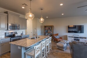 Kitchen - The kitchen is fully stocked with all the dishes, cookware, baking pans, and cutlery you will need for meal preparations and includes stainless steel appliances and granite counter tops.