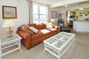 Living room with memory foam sleeper sofa, cable TV, breakfast nook, and balcony