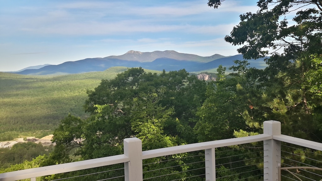 An expansive mountain view from a balcony at a vacation home in New Hampshire