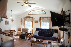 Bright spacious living area with queen futon, wifi and a smart television.