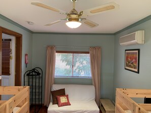 Second bedroom with a couple of bunk beds and a sleeper couch.