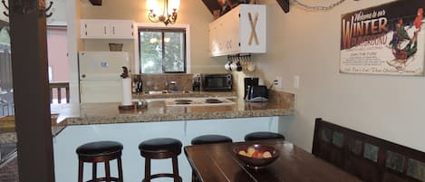 Dining Room and Kitchen with granite countertops. Seating for 10.