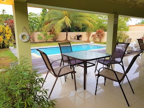 Relax outdoors with views of the pool and BBQ area