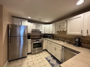Fully equipped kitchen with electric stove, dishwasher, microwave, etc.