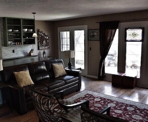 Living room overlooking the enclosed hidden patio with gas grill.