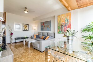 Another view of living room with ceiling fan