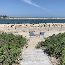 Sandy beach at end of our path with great jetty and water views.