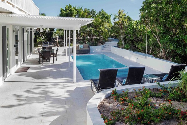 Immerse yourself in luxury with a private pool accompanied by a rejuvenating Jacuzzi. The surrounding landscape is adorned with vibrant, lush greenery, creating a tranquil oasis. Additionally, an outdoor dining and seating area, complete with a barbecue set, provides the perfect setting for delightful meals and relaxation