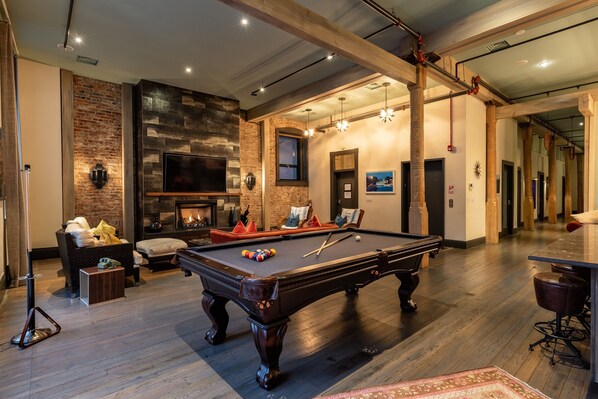 Pool table by living area and kitchen 