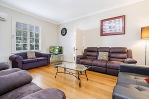 lounge room and entry to third bedroom